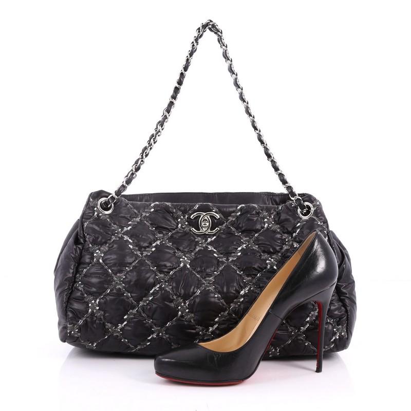 This authentic Chanel Tweed on Stitch Tote Quilted Nylon Large is stylish and unique for the modern woman. Crafted from black nylon in Chanel's trademark diamond quilting with quilted tweed, this adorable bag features dual woven-in leather chain