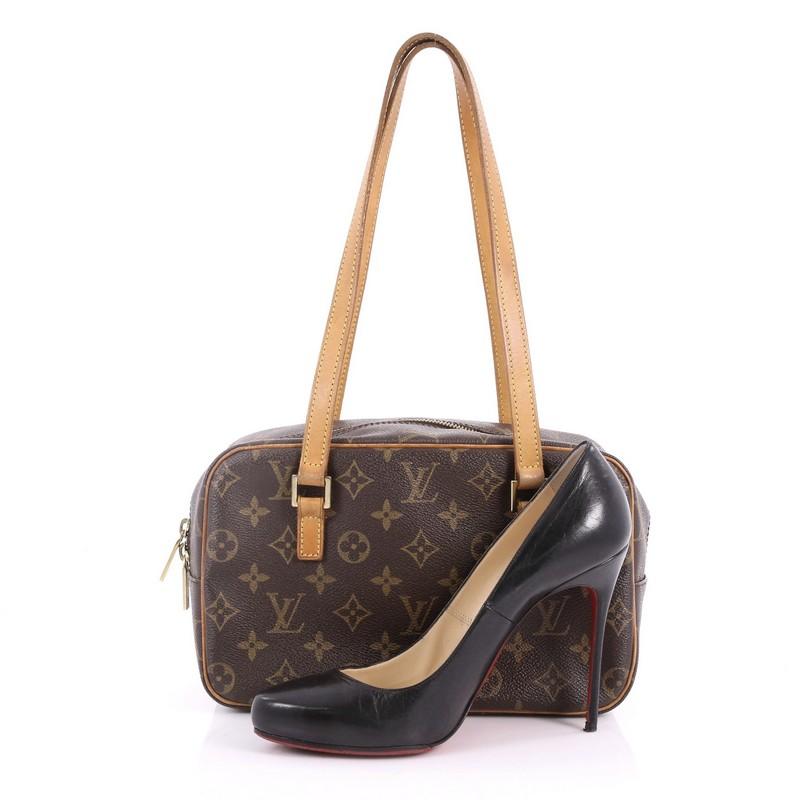 This authentic Louis Vuitton Cite Handbag Monogram Canvas MM is perfect for everyday use. Crafted in brown monogram coated canvas with vachetta leather trims, this bag features long-dual flat vachetta leather handles, front zip pocket and gold-tone