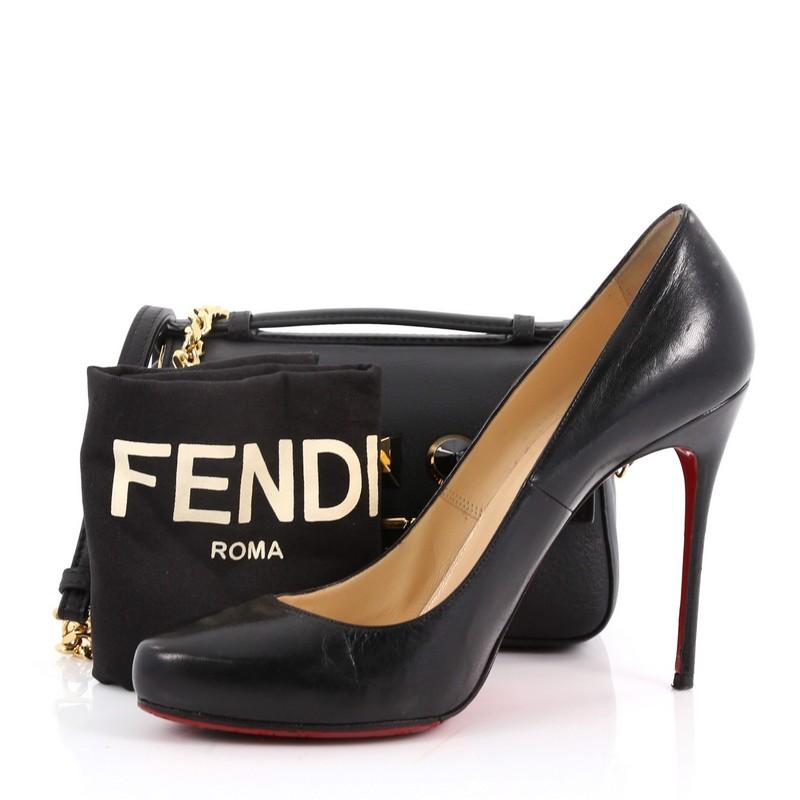 This authentic Fendi Double Baguette Studded Leather Micro is a winner in terms of practicality as well as in style. Crafted from black leather, this stylish bag features flat top leather handle, chain-link and leather shoulder strap, ABS studs, two