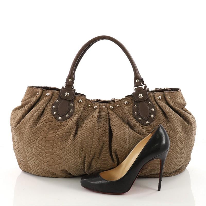 This authentic Gucci Pelham Tote Studded Python Large is perfect for any casual or sophisticated outfit. Crafted from genuine brown python skin, this tote features dual-rolled top handles, ruched silhouette, studs detailing, and gold-tone hardware