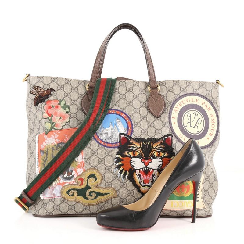 This authentic Gucci Convertible Courrier Soft Open Tote GG Coated Canvas with Applique Large is a source of travel inspiration for Gucci's creative director Alessandro Michele. Crafted in light taupe GG coated canvas with brown leather trims, this