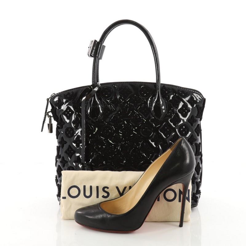 This authentic Louis Vuitton Fascination Lockit Handbag Patent Lambskin is perfect for your daily excursions. Crafted in black patent leather embroidered with LV's iconic monogram bouclette design, this one-of-a-kind petite handle bag features