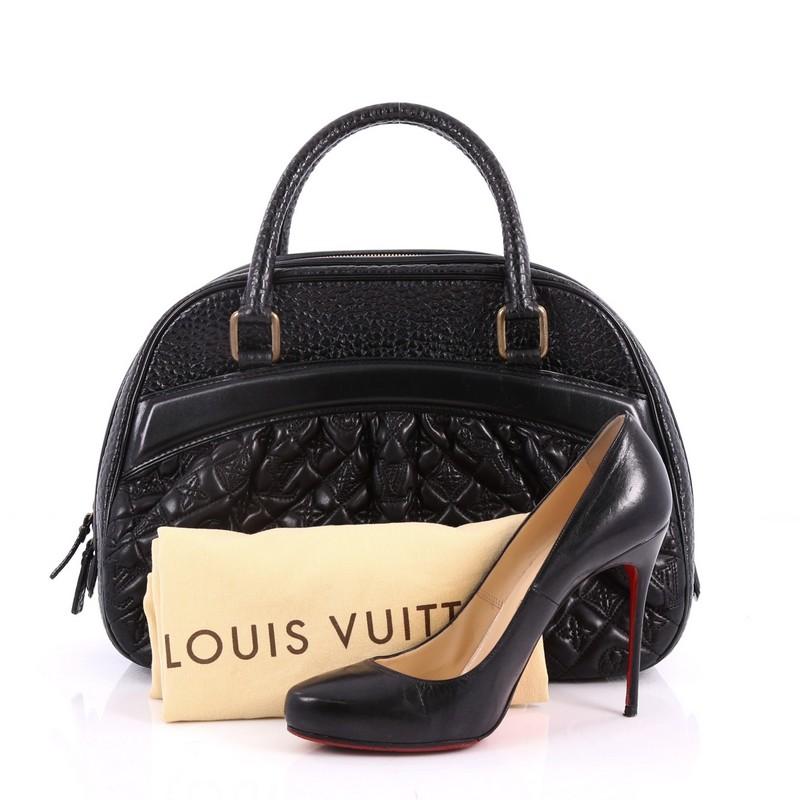 This authentic Louis Vuitton Mizi Vienna Handbag Monogram Quilted Lambskin is a rare, luxurious piece. Crafted from black quilted leather in a meticulously embroidered monogram pattern, this bag features a ruched silhouette, dual rolled handles,