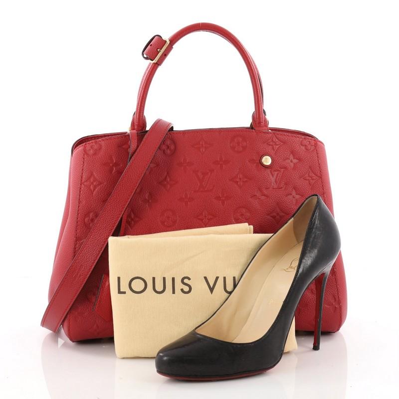 This authentic Louis Vuitton Montaigne Handbag Monogram Empreinte Leather MM is as sophisticated as it is sturdy. Crafted in red monogram empreinte leather, this luxurious and refined bag features dual-rolled leather handles, protective base studs