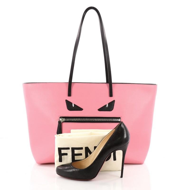 This authentic Fendi Monster Roll Tote Leather Medium is a uniquely kitschy tote, perfect for everyday looks. Crafted from pink leather, this eye-catching, lightweight tote features dual slim leather straps, front zip pocket designed as the