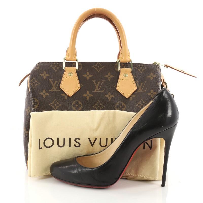 This authentic Louis Vuitton Speedy Handbag Monogram Canvas 25 is a classic must-have, making it ideal for everyday use. Constructed from Louis Vuitton's classic brown monogram coated canvas, this iconic Speedy features dual-rolled vachetta leather