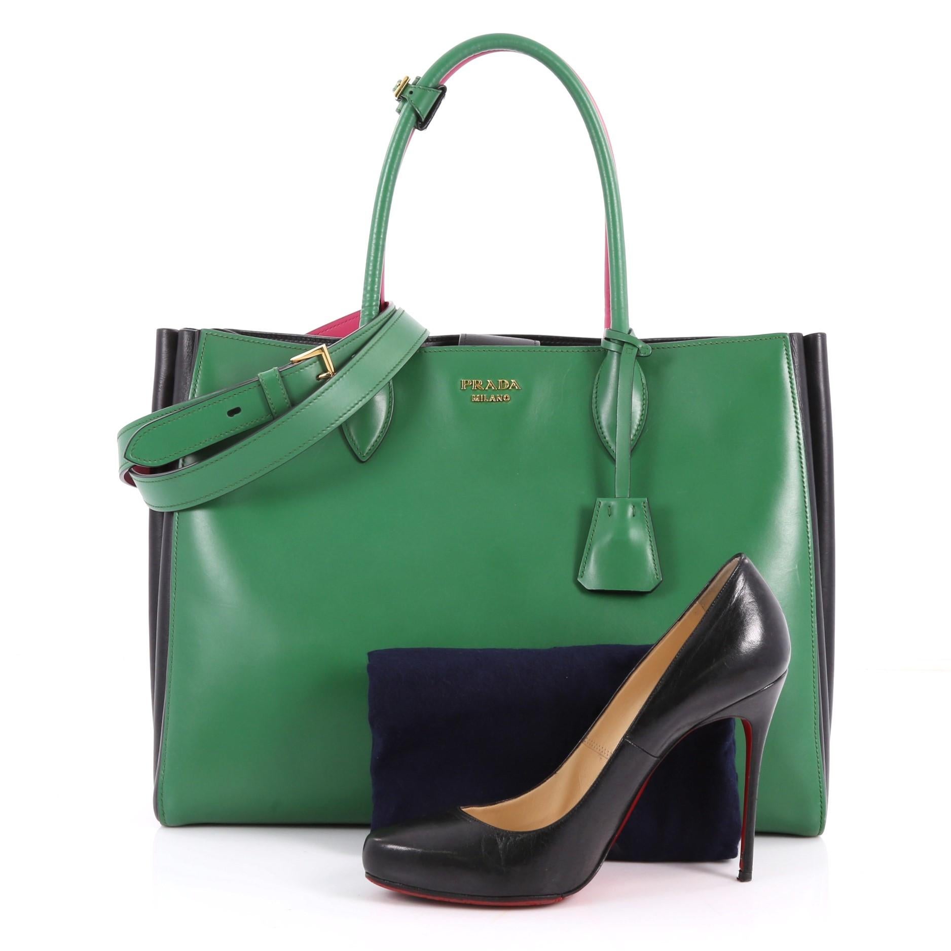 This authentic Prada Soft Bibliotheque Handbag City Calfskin Large is a mark of Prada's fine craftsmanship that is elegant in its simplicity and structure. Crafted from green, black, pink and white calfskin leather, this tote features dual-rolled