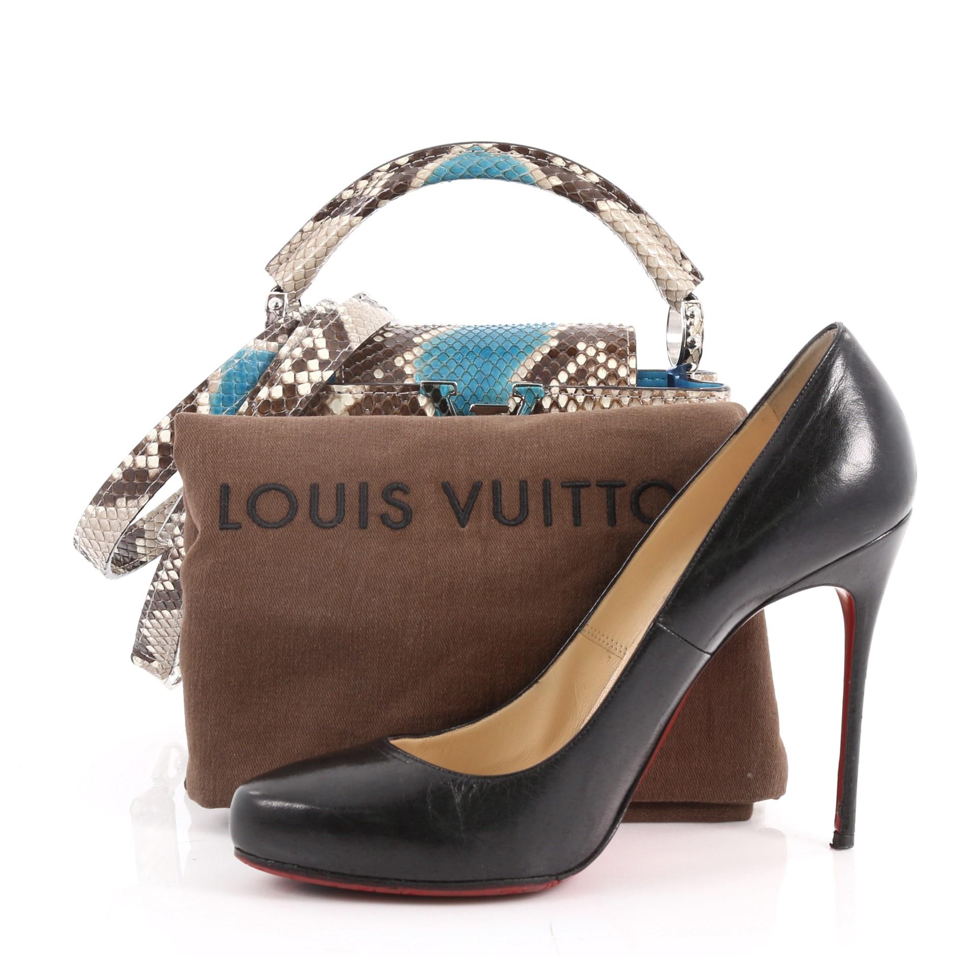 This authentic Louis Vuitton Capucines Handbag Python Mini is a sophisticated and ladylike luxurious bag inspired by the brand's Parisian heritage. Crafted in genuine brown and teal python skin, this chic, stand-out bag features a single loop