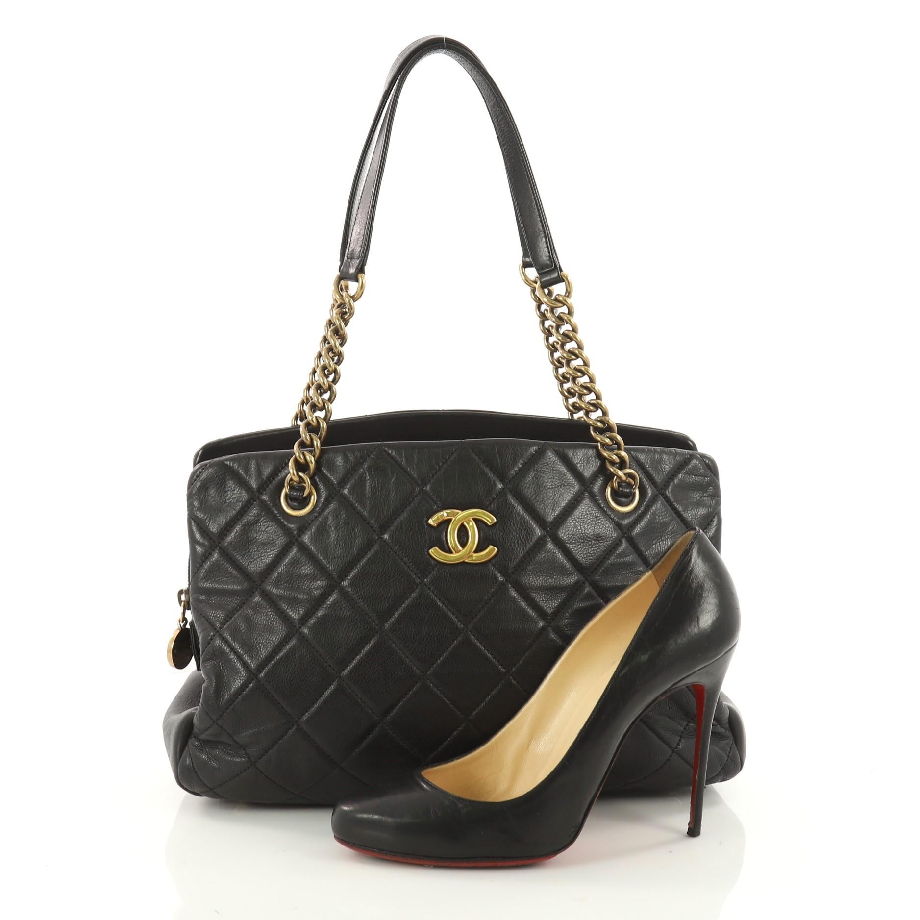 This authentic Chanel CC Crown Tote Quilted Leather Medium mixes chic style with vintage-inspired detailing. Crafted in black quilted leather, this chic tote features gold chain straps with leather pads, protective base studs and center CC logo. It