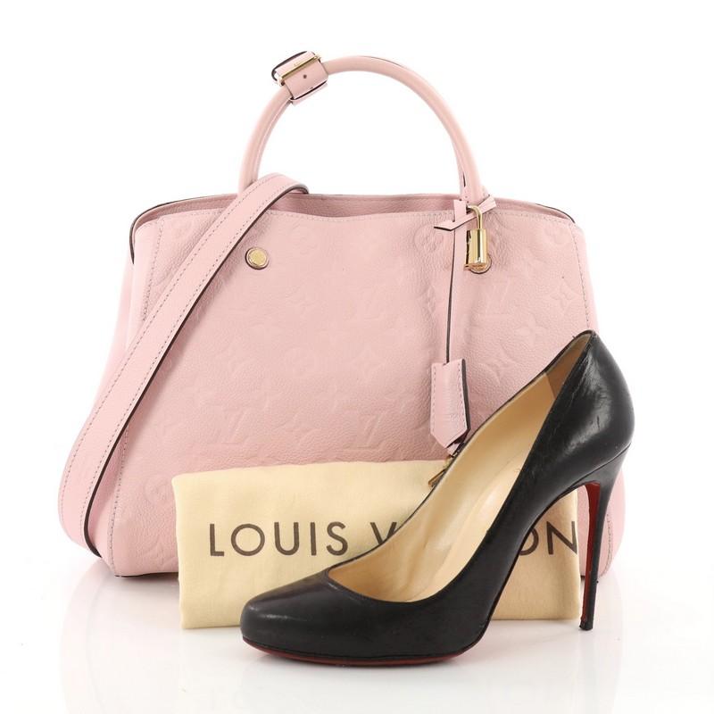 This authentic Louis Vuitton Montaigne Handbag Monogram Empreinte Leather MM is as sophisticated as it is sturdy. Crafted in pink embossed monogram empreinte leather, this luxurious and refined bag features dual-rolled leather handles, protective