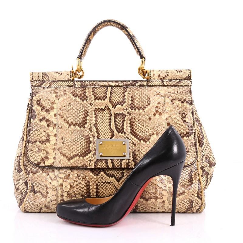 This authentic Dolce & Gabbana Miss Sicily Handbag Python Large pays homage to the designers' Sicilian heritage with a fresh twist. Crafted from genuine tan python, this bag features python skin top handle, designer plaque, and gold-tone hardware