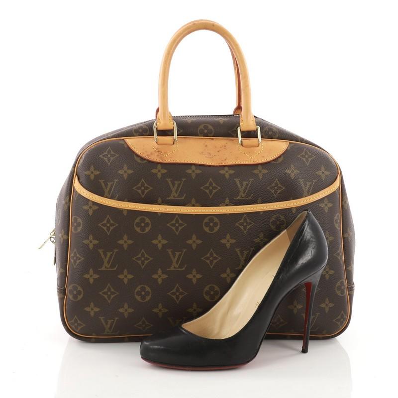 This authentic Louis Vuitton Deauville Handbag Monogram Canvas was popularly known as a vanity case yet has become an everyday staple. Constructed from brown monogram coated canvas, this bag features dual rolled vachetta leather handles and trims,