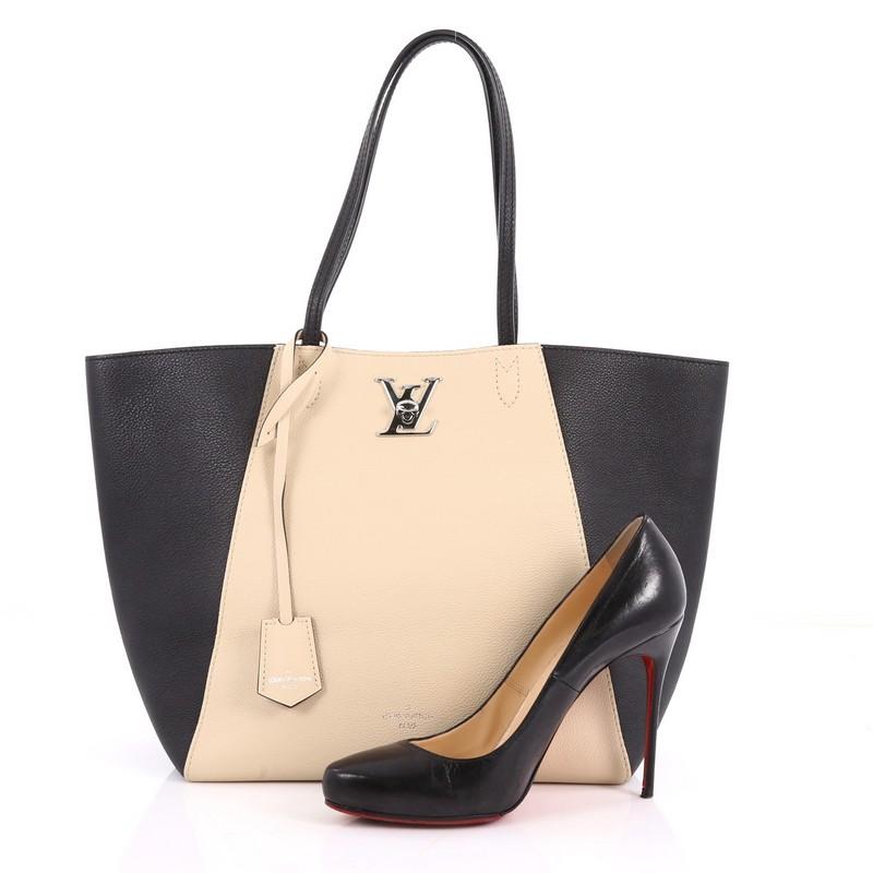 This authentic Louis Vuitton Lockme Cabas Leather is a gorgeous and sophisticated bag that is a must-have on your collection. Crafted from beige and black leather, this bag features dual flat leather handles, LV twist closure, and silver-tone