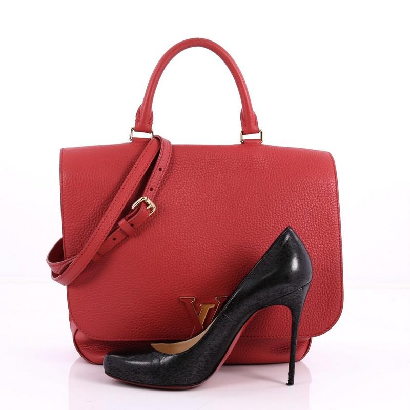 This authentic Louis Vuitton Volta Handbag Leather updates its modern, minimalist design following the popular Capucines line. Crafted from red leather, this elegant satchel features a subtle leather-covered LV logo on its flap, rolled leather