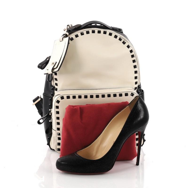 This authentic Valentino Rockstud Backpack Leather Medium is stylish and chic in design perfect for on the go moments. Crafted from black and white leather, this backpack features black rockstuds trims, exterior front zip pocket, adjustable backpack