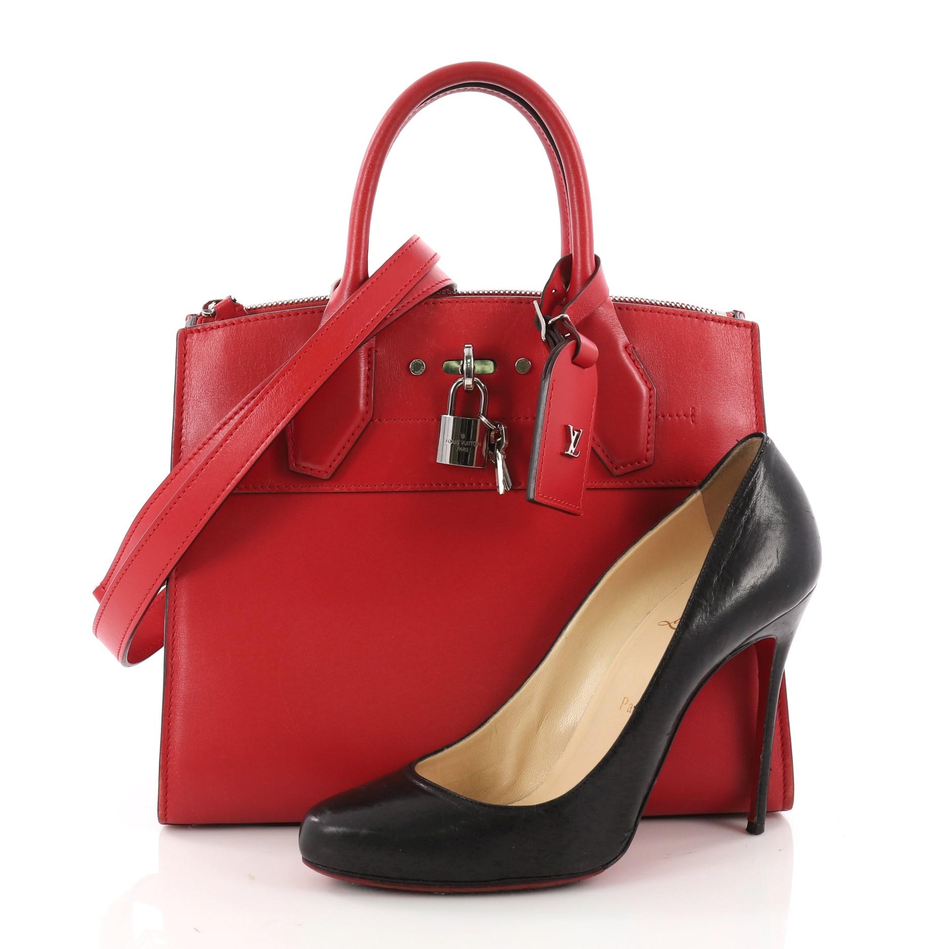 This authentic Louis Vuitton City Steamer Handbag Leather PM is a versatile bag fit for a dressy as well as a casual day out. Crafted in red leather, this modern day tote features dual-rolled leather handles, front central lock with LV stamped logo,