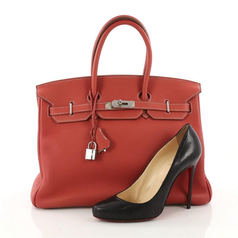 This authentic Hermes Eclat Birkin Handbag Sanguine and White Clemence with Palladium Hardware 35 showcases subtle elegance. Finely crafted in beautiful red eclat sanguine and white clemence leather, this piece features dual-rolled top handles,