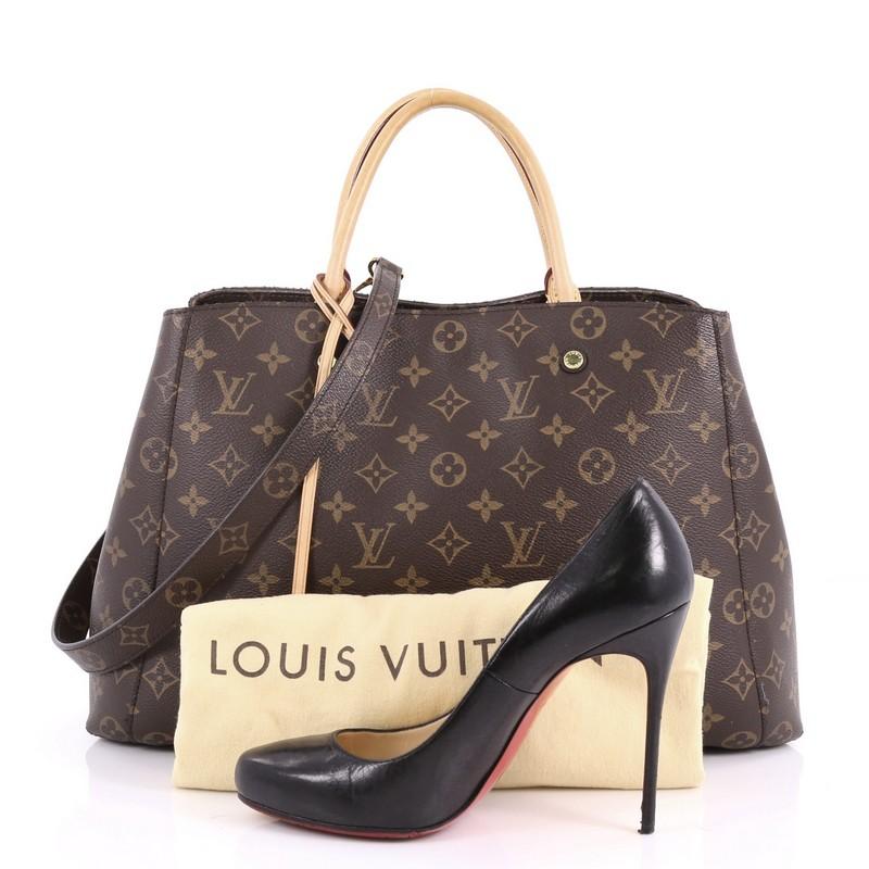 This authentic Louis Vuitton Montaigne Handbag Monogram Canvas GM named after the famed Parisian location, is as sophisticated as it is sturdy. Crafted from the iconic brown monogram coated canvas, this tote features dual-rolled vachetta leather