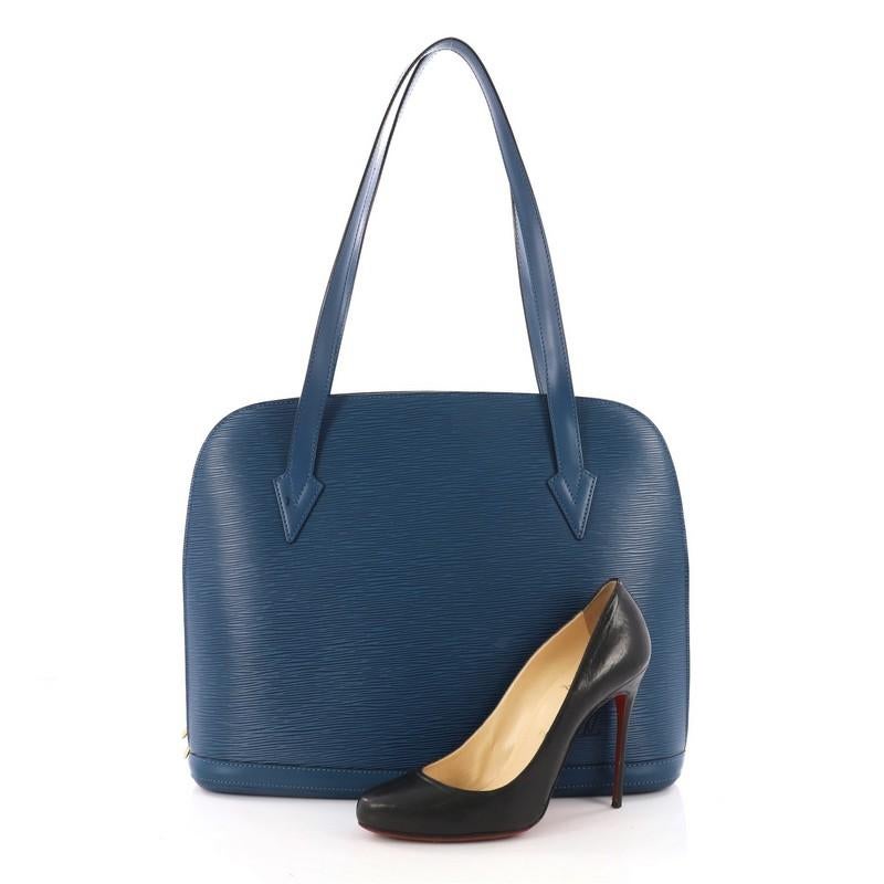 This authentic Louis Vuitton Lussac Handbag Epi Leather is a chic and sophisticated bag perfect for your everyday use. Constructed with Louis Vuitton's signature sturdy blue epi leather, this bag features dual flat leather straps, subtle LV logo,
