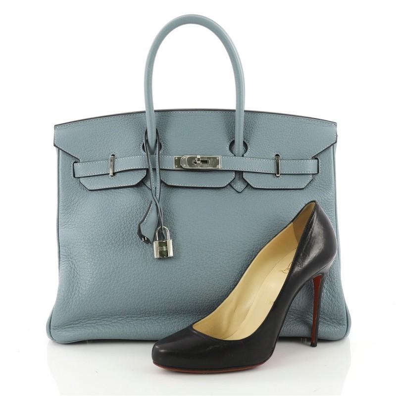 This authentic Hermes Birkin Handbag Ciel Blue Clemence with Palladium Hardware 35 stands as one of the most-coveted accessory made for the modern woman. Crafted from Ciel Blue Clemence leather, this stand-out tote features dual-rolled top handles,