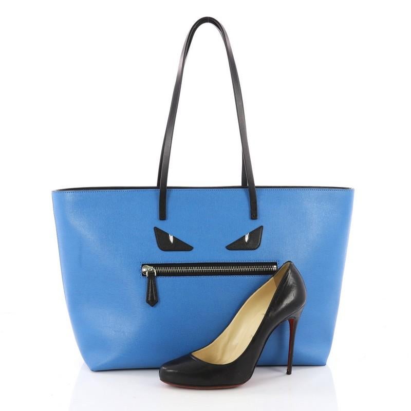 This authentic Fendi Monster Roll Tote Leather Medium is a uniquely, kitschy tote perfect for everyday looks. Crafted from blue leather, this eye-catching, lightweight tote features dual slim leather straps, front zip pocket designed as the