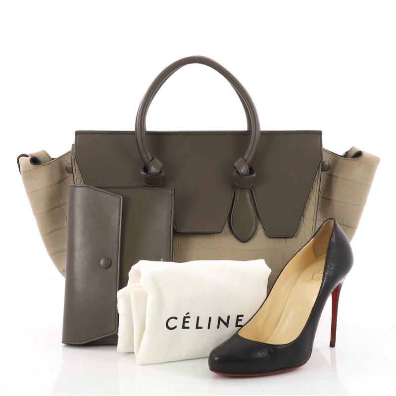 This authentic Celine Tie Knot Tote Crocodile Embossed Nubuck Small is an absolute must-have for serious fashionistas. Crafted from beige embossed crocodile nubuck and leather, this boxy chic tote features dual-rolled leather handles with signature