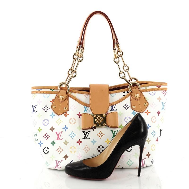 This authentic Louis Vuitton Annie Handbag Monogram Multicolor GM is a unique and rare piece perfect for modern fashionistas. Crafted in white multicolor monogram coated canvas, this tote features dual leather straps with gold chain links, natural