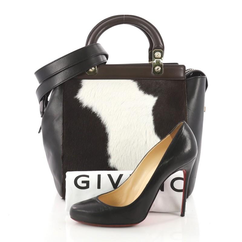 This authentic Givenchy HDG Tote Pony Hair and Leather Small is a refined and elegant bag. Crafted in brown black and white pony hair and leather, this bag features winged gusset and frame top, dual rigid leather top handles, a small HDG logo and