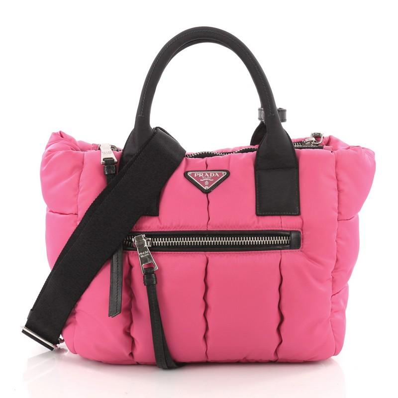 This authentic Prada Double Zip Convertible Bomber Tote Tessuto Medium is simple yet luxurious, perfect for everyday use. Crafted in pink tessuto nylon, this chic-casual tote features a signature raised Prada logo at the center, dual-rolled fabric
