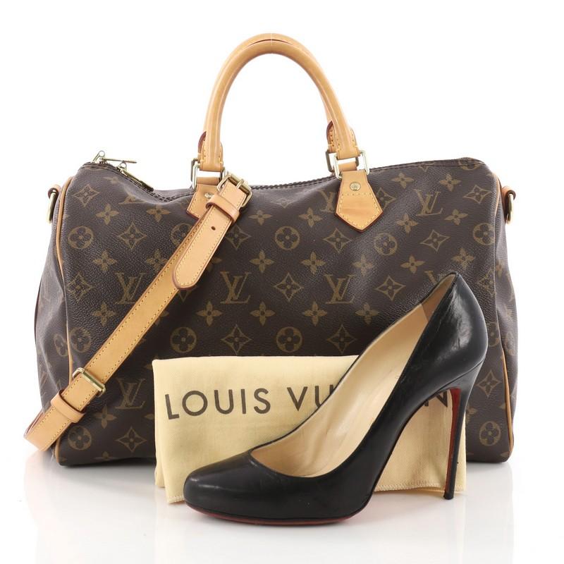 This authentic Louis Vuitton Speedy Bandouliere Bag Monogram Canvas 35 is a versatile and classic accessory made for everyday use. Crafted from Louis Vuitton's brown monogram coated canvas, this updated Speedy features dual-rolled vachetta leather