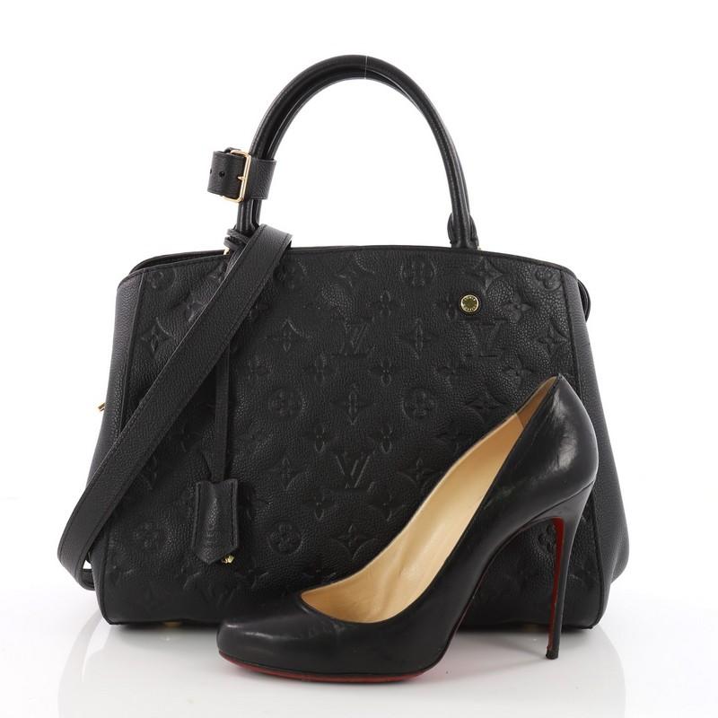 This authentic Louis Vuitton Montaigne Handbag Monogram Empreinte Leather MM is as sophisticated as it is sturdy. Crafted in black monogram empreinte leather, this luxurious and refined bag features dual-rolled leather handles, protective base studs