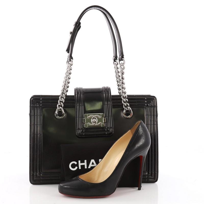 This authentic Chanel Boy Tote Glazed Calfskin Small, designed by Karl Lagerfeld, is perfect for the modern fashionista. Crafted from black glazed calfskin leather, this stylish bag features dual flat leather handles, a chain-link shoulder strap and