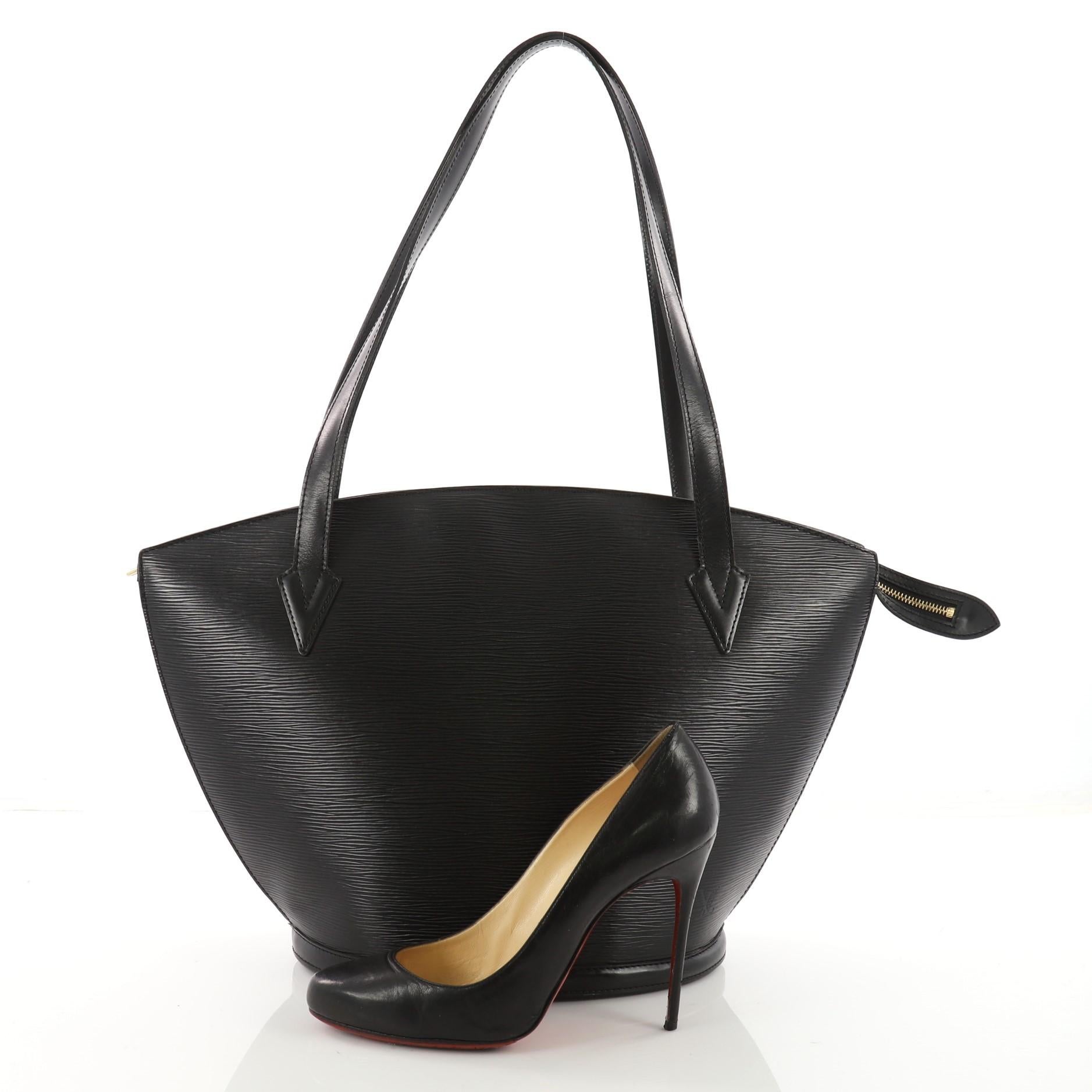 This authentic Louis Vuitton Saint Jacques Handbag Epi Leather GM is refined and elegant. Crafted from Louis Vuitton's signature black epi leather and sturdy base, this fan-shaped bag features dual leather straps, subtle LV logo at the front and