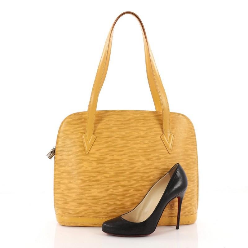 This authentic Louis Vuitton Lussac Handbag Epi Leather is a chic and sophisticated bag perfect for your everyday use. Constructed with Louis Vuitton's signature sturdy yellow epi leather, this bag features dual flat leather straps, subtle LV logo,