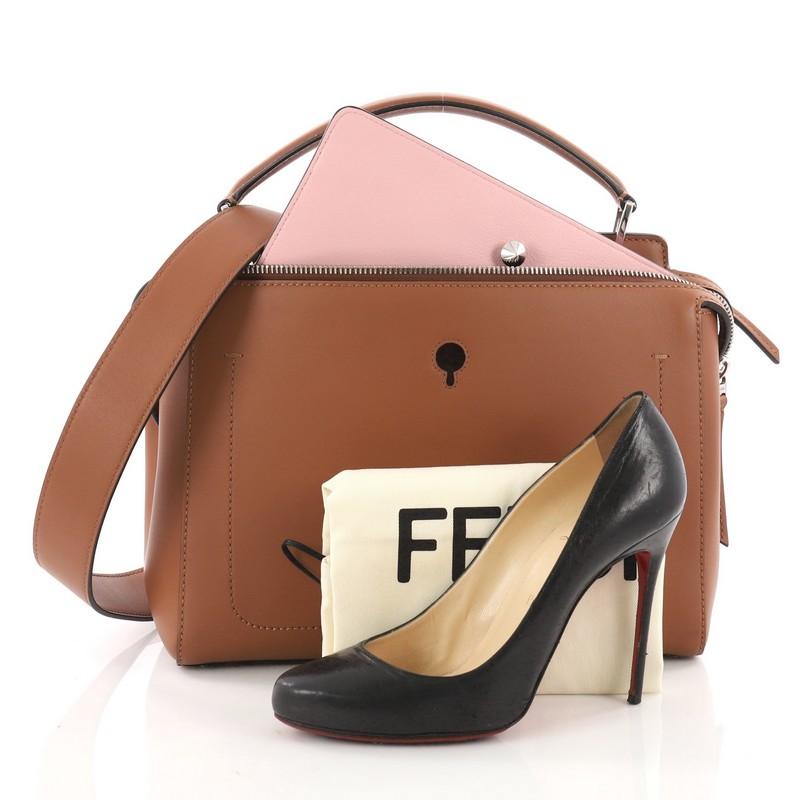 This authentic Fendi DotCom Convertible Satchel Leather Medium is a chic and minimalist bag perfect for your everyday looks. Crafted from brown leather, this understated satchel features a flat top handle, removable shoulder strap, distinctive