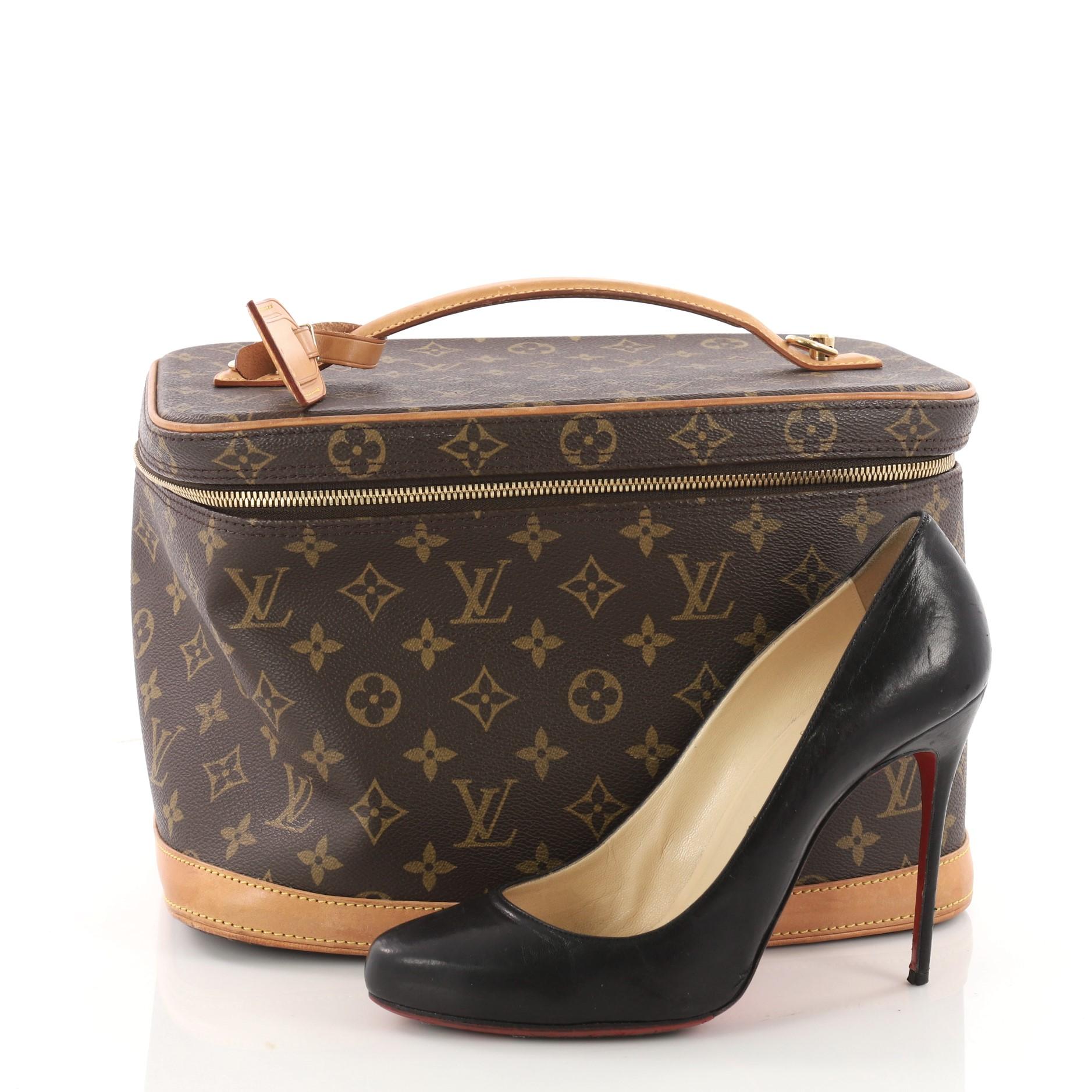 This authentic Louis Vuitton Nice Train Case Monogram Canvas is a perfect travel companion for an on-the-go fashionista. Crafted from brown monogram coated canvas, this boxy travel bag features vachetta leather flat handle and trims and gold-tone