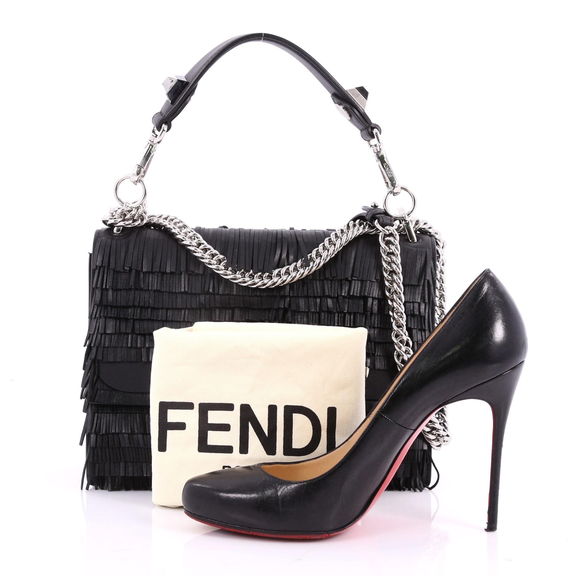 This authentic Fendi Monster Kan I Handbag Fringe Leather Medium is a uniquely designed bag perfect for any stylish fashionista. Crafted from black fringe leather, this bag features a flat top handle with ABS studs, chain-link shoulder strap, double