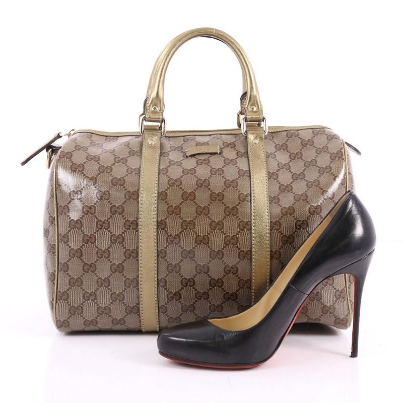 This authentic Gucci Joy Boston Bag GG Imprime Medium is a simple and stylish companion perfect for daily use. Crafted in brown imprime GG coated canvas with gold leather trim, this satchel features dual-rolled handles and gold-tone hardware