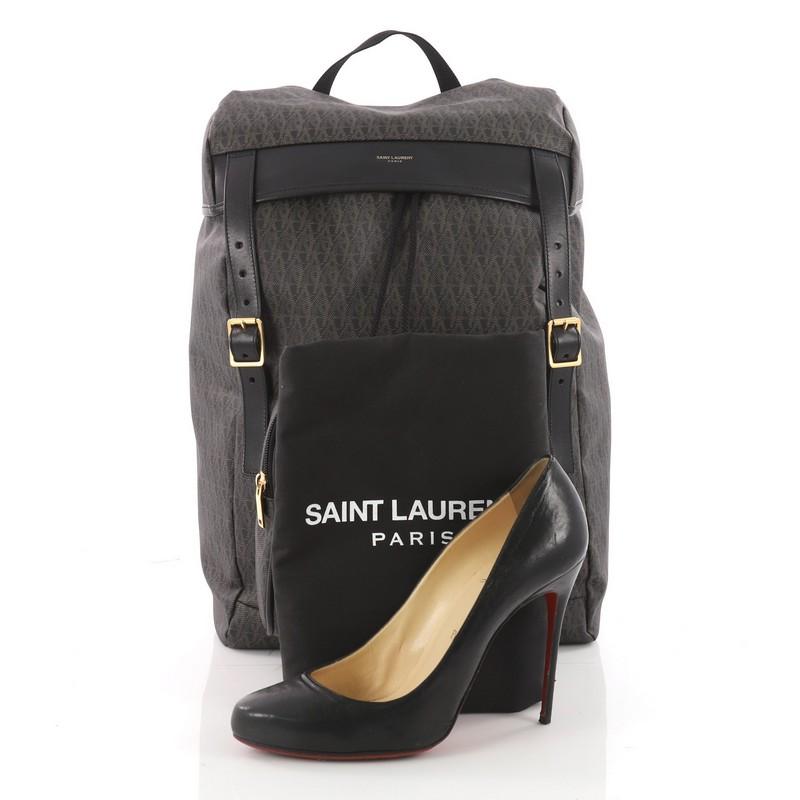 This authentic Saint Laurent Hunting Backpack Coated Monogram Canvas is a luxe backpack combining style and comfort. Crafted from black coated monogram canvas with black leather trims, this runway-ready backpack features dual adjustable backpack