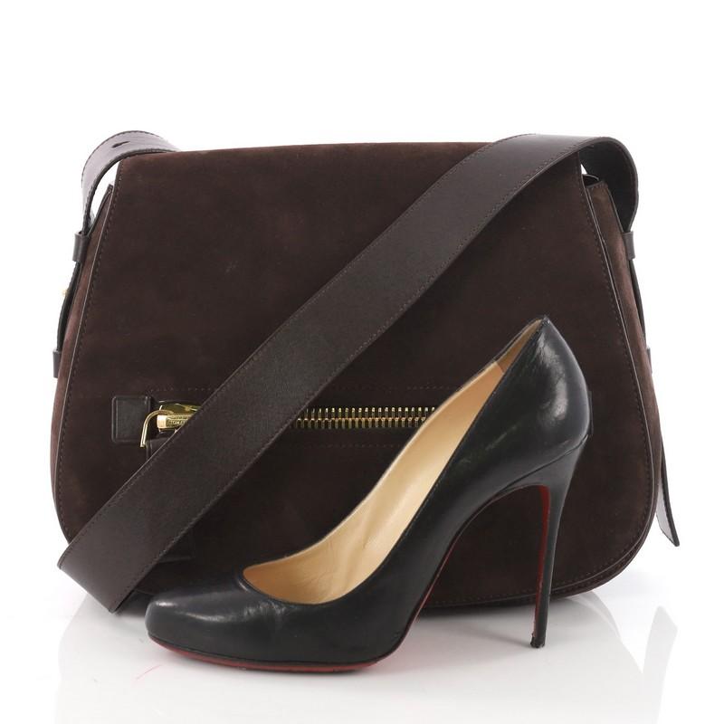This authentic Tom Ford Jennifer Soft Saddle Bag Suede with Leather Medium redefines modern luxury with timeless elegance. Crafted in brown suede and leather, this saddle bag features an adjustable leather strap, exterior zip pocket at front flap,