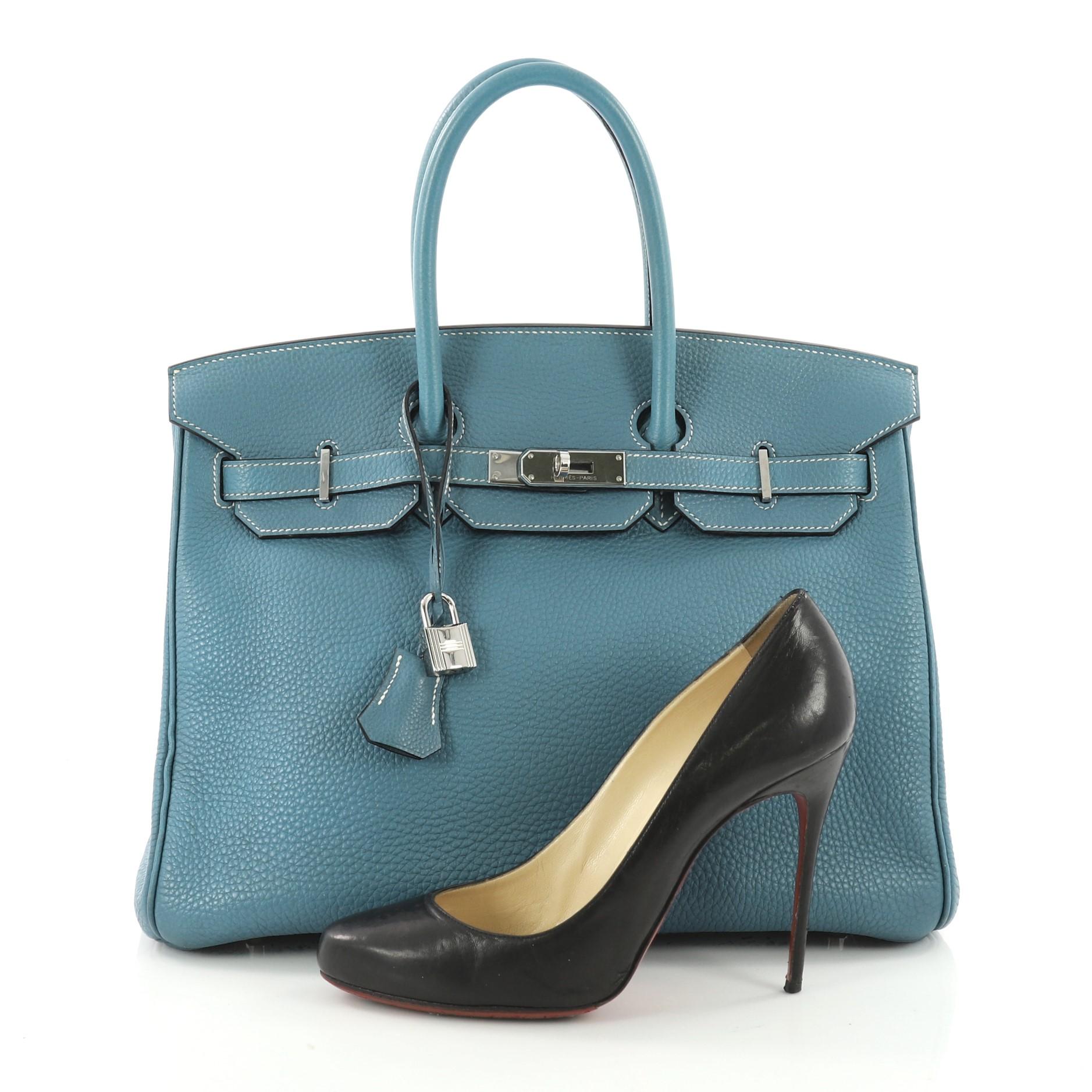 This authentic Hermes Birkin Handbag Blue Jean Togo with Palladium Hardware 35 stands as one of the most-coveted bags. Constructed from scratch-resistant Blue Jean togo leather, this stand-out tote features dual-rolled top handles, frontal flap,