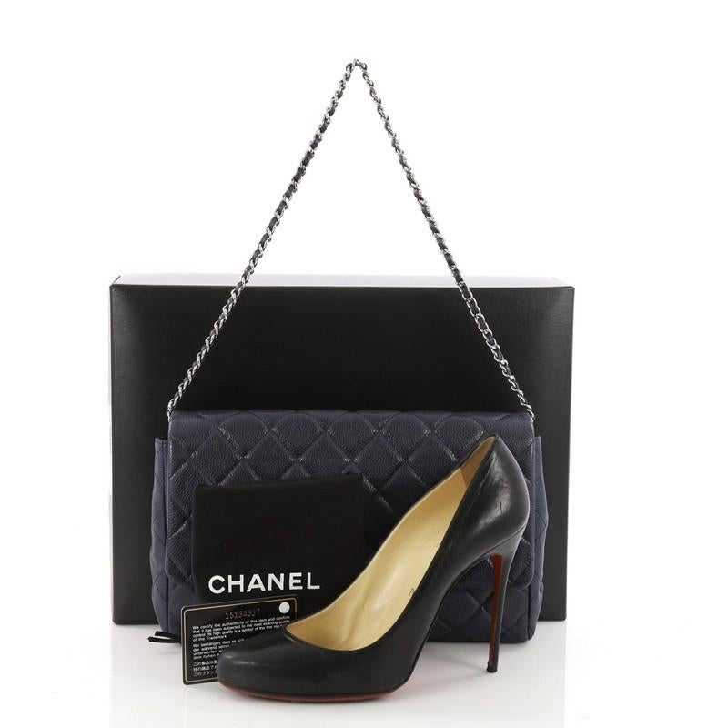 This authentic Chanel Clutch with Chain Quilted Caviar is an elegant accessory that adds a touch of glamour to any look. Crafted from navy blue quilted caviar leather, this clutch features Chanel's signature diamond quilting, exterior back slip