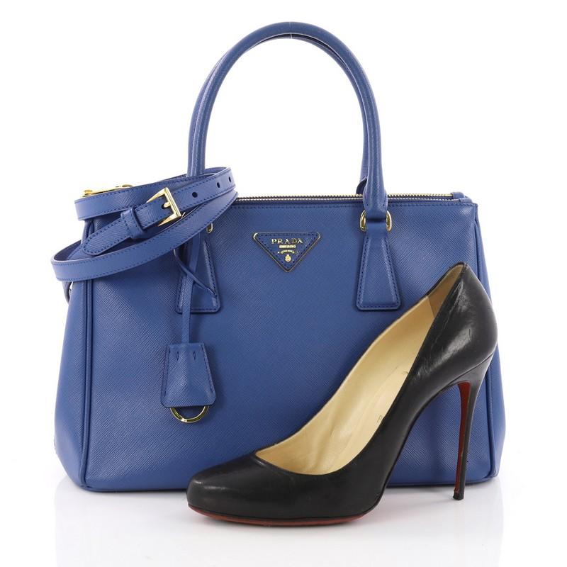This authentic Prada Double Zip Lux Tote Saffiano Leather Small is the perfect bag to complete any outfit. Crafted from blue saffiano leather, this boxy tote features side snap buttons, raised Prada logo plate, dual-rolled leather handles and
