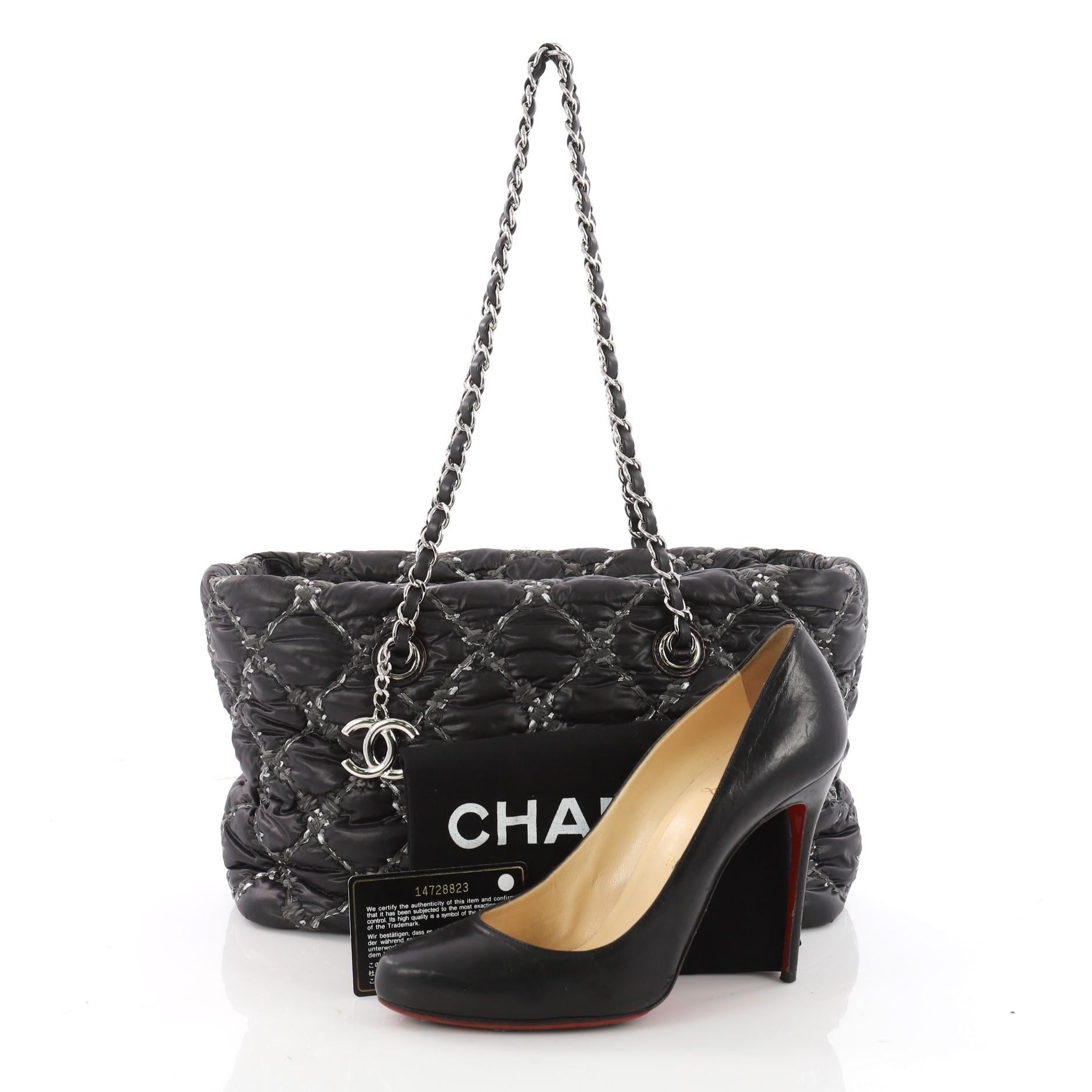 This authentic Chanel Tweed on Stitch Zip Tote Quilted Nylon Small is stylish and unique for the modern woman. Crafted from black nylon in Chanel's trademark diamond quilting with quilted tweed, this adorable bag features dual woven-in leather chain