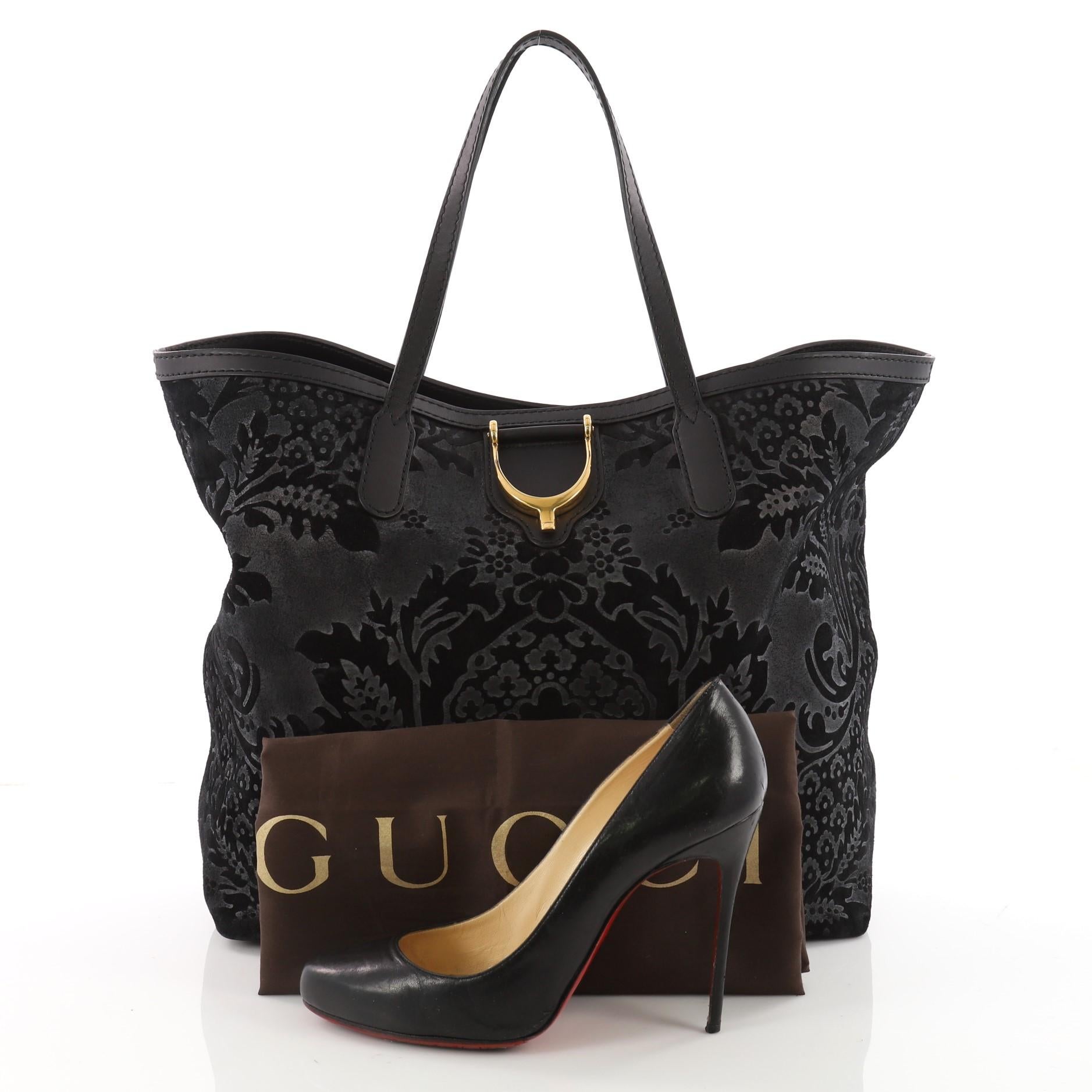 This authentic Gucci Stirrup Tote Brocade Leather is sophisticated yet playful at the same time. Crafted from black brocade damask-patterned embossed nubuck leather and suede, this intricate tote features dual-flat leather handles, black leather