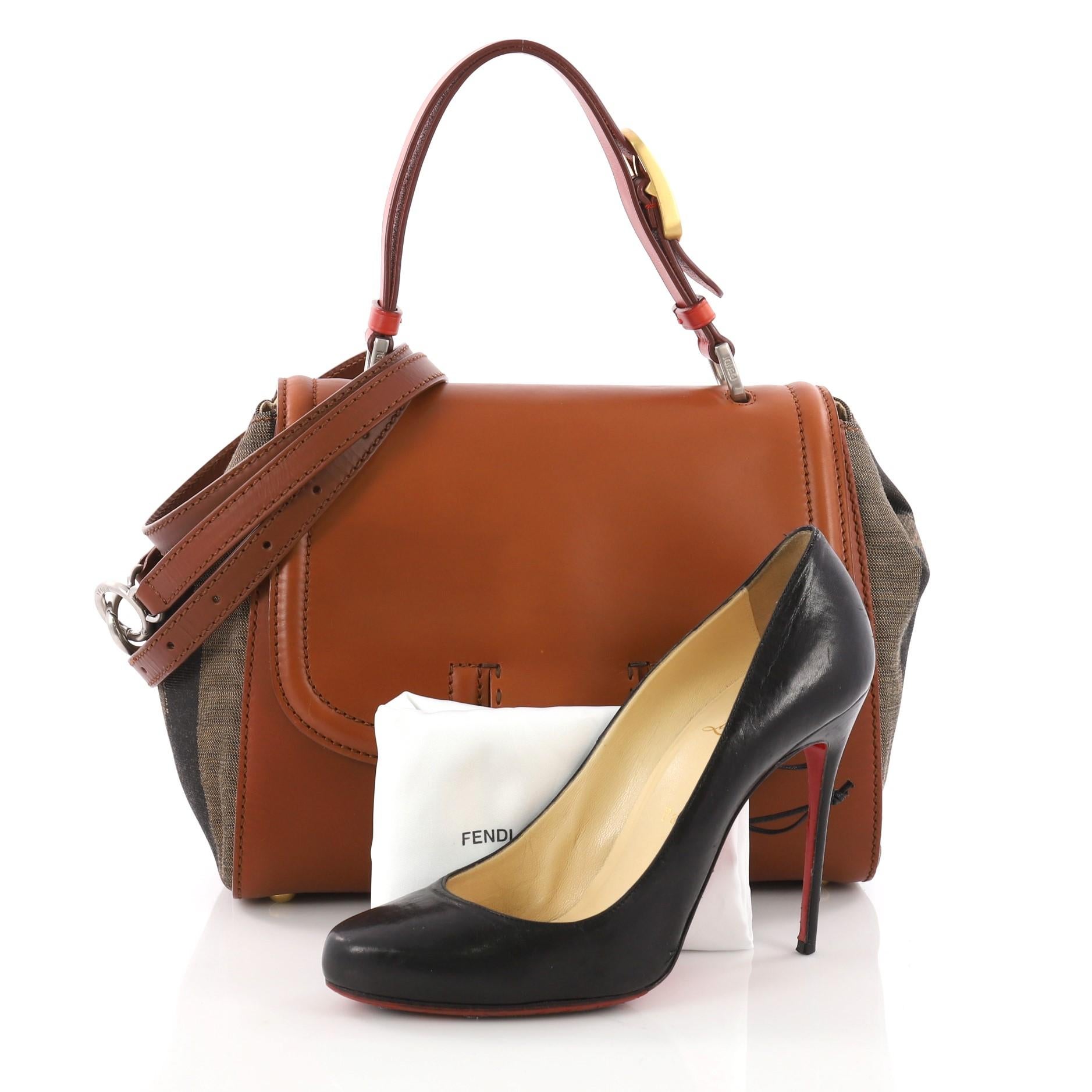 This authentic Fendi Silvana Bag Leather with Pequin Striped Canvas Small is a sophisticated tote made for everyday use. Crafted from brown leather with side pequin striped canvas, this satchel features a flat leather top handle with buckle