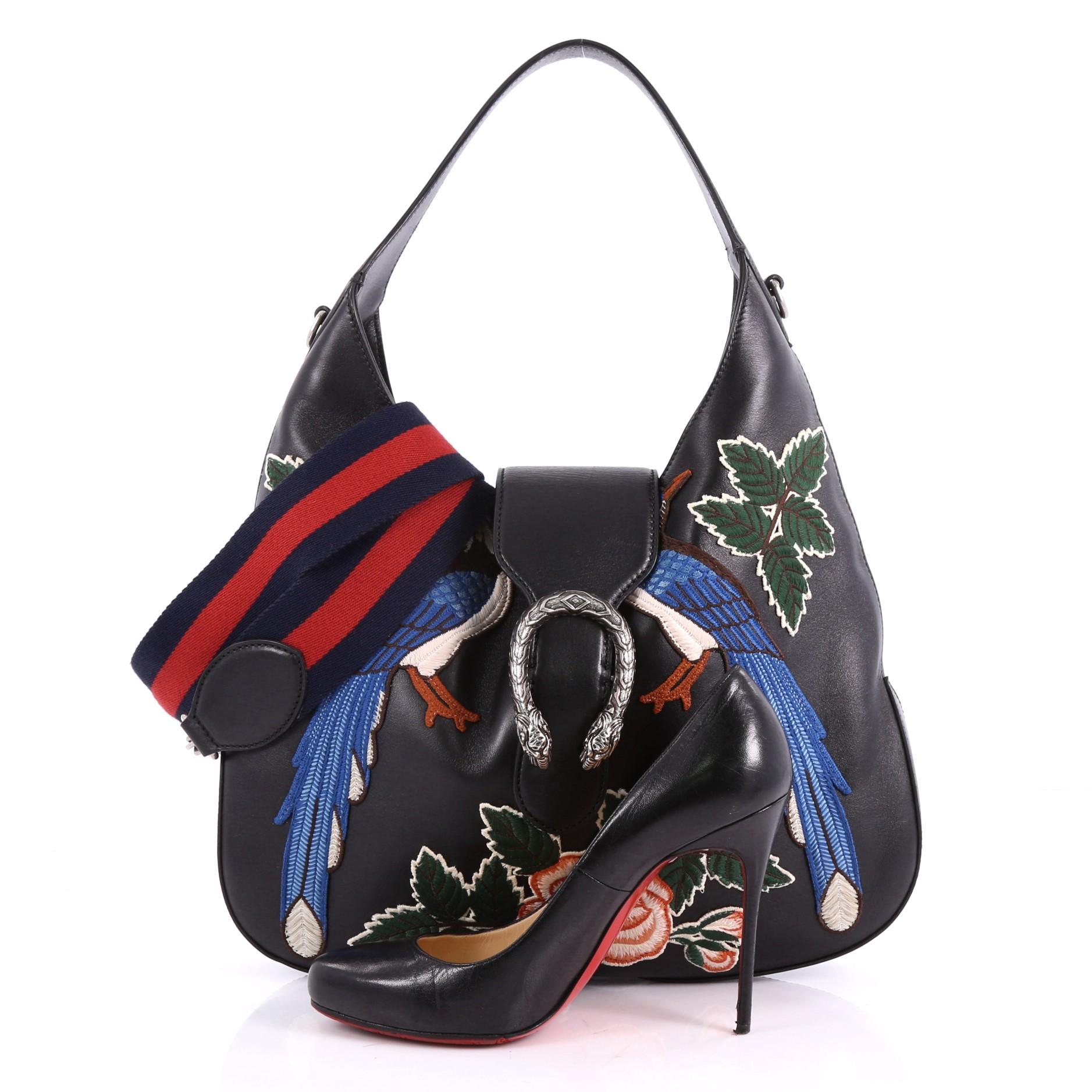 This authentic Gucci Dionysus Hobo Embroidered Leather Small is a modern and stylish bag perfect to add to your collection. Crafted from black embroidered leather, this hobo features a single loop leather handle, beaded peacocks and floral