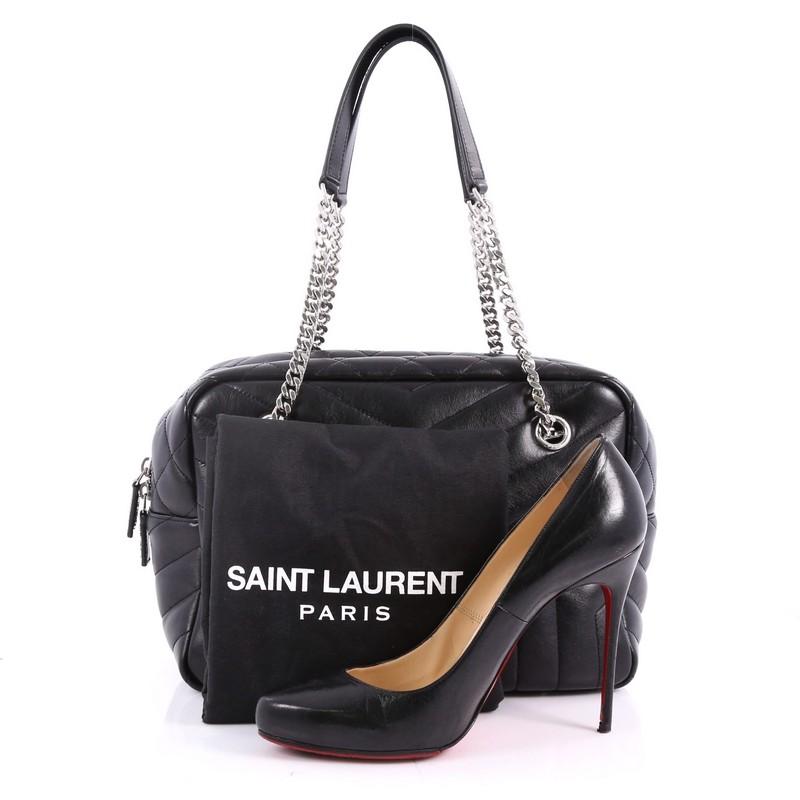 This authentic Saint Laurent LouLou Bowling Bag Matelasse Chevron Leather Medium combines a modern and functional style with an edgy twist. Crafted in black chevron matelasse leather, this bag features a dual chain-link strap with shoulder pad, YSL