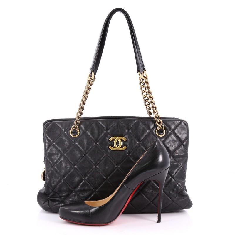 This authentic Chanel CC Crown Tote Quilted Leather Medium mixes chic style with vintage-inspired detailing. Crafted in black quilted leather, this chic tote features gold chain straps with leather pads, protective base studs and center CC logo. It