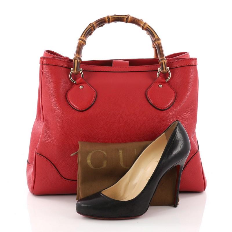 This authentic Gucci Diana Bamboo Top Handle Tote Leather Medium is a chic tote ideal for your everyday wear. Crafted from red leather, this tote features dual bamboo top handles, gusseted sides, protective base studs, and gold-tone hardware